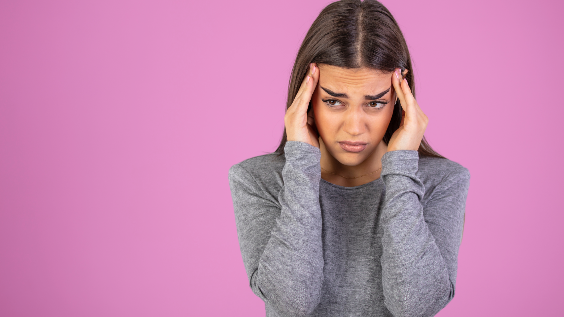 Woman holding head Pink Concussion